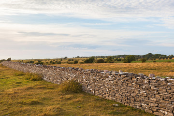 High stone wall in sunset