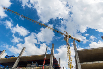 Construction site with cranes on blue sky background