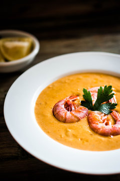 Shrimp soup with mussels on rustic background