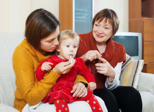  Mother With Mature Grandmother Caring For Sick Baby