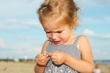 offended crying little girl on the beach.