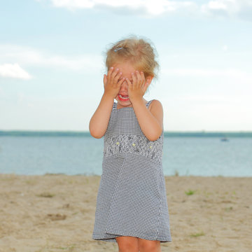 offended crying little girl on the beach.