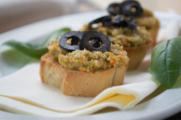 Bread slice with olive cream and black olives on top