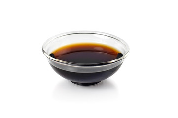 Soy sauce in bowl on white background