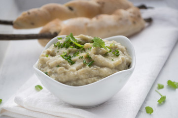 Baba ganoush with herbs, campfire bread behind