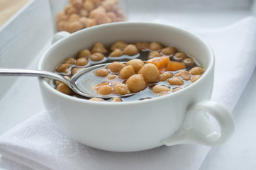 Fried batter pearls in soup with spoon
