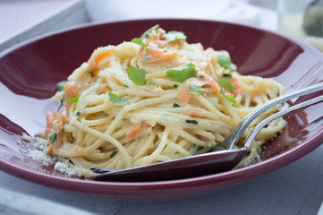 Vegetable pasta with spoon in front