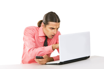 Young man with laptop looking at the monitor over white backgrou