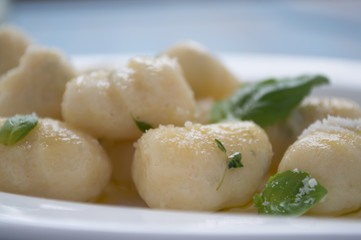 Gnocchi with herbs on plate side view