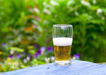 Glass of beer on a picnic table