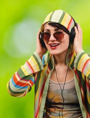 Young attractive brunette listens to music through headphones.
