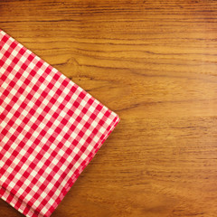 Fototapeta na wymiar Wooden table with red checked tablecloth