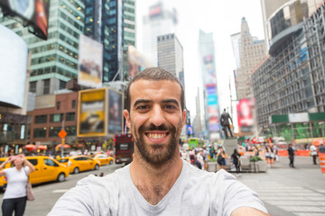 Obraz premium Young Man Taking Selfie in Times Square