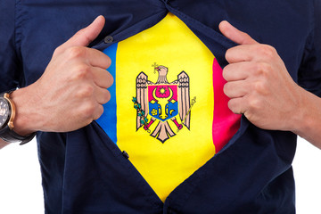Young sport fan opening his shirt and showing the flag his count