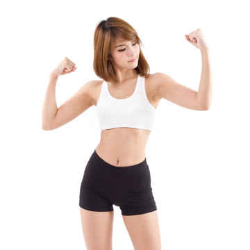 strong, fit, firm woman checking her arm muscle strength