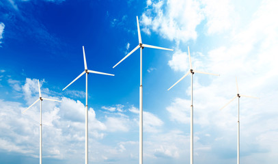 Green renewable energy concept - wind generator turbines in sky