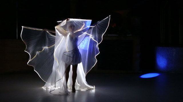actress girl in white with LED wings