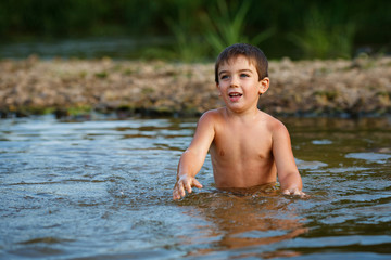 Fototapeta premium A child plays in the water