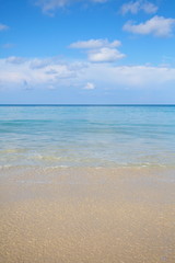 Fototapeta na wymiar Natural background of sand beach and blue sky