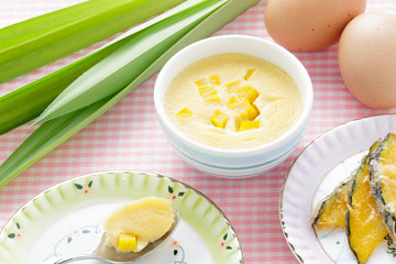 Thai dessert,  steamed custard in blue Bowl with ingredient.