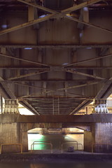 steel construction from under the old bridge at night time