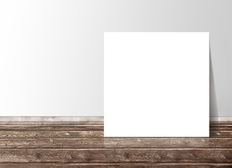 Blank white square paper template banner on the wooden floor aga