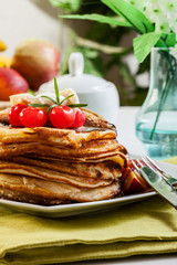 Pancakes with chocolate sauce fruit and coffee