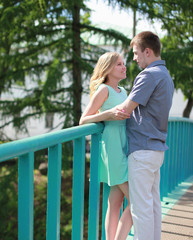 Pretty happy couple on the bridge in love