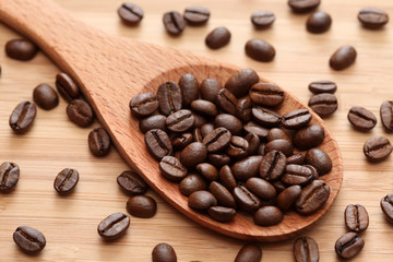Coffee beans in a wooden spoon