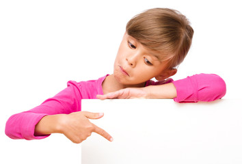 Little girl is looking out from the blank banner