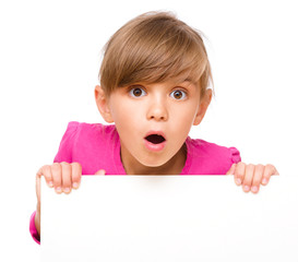 Little girl is looking out from the blank banner