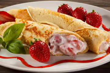 Pancakes with cream and strawberries