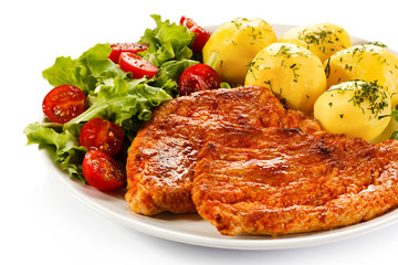 Fried pork chop, boiled potatoes and vegetable salad