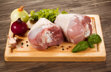 Raw turkey legs on cutting board 