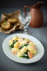 Italian gnocchi served with salmon and basil