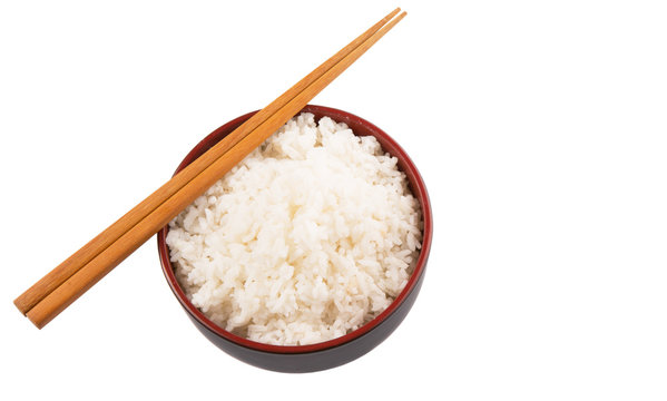 A bowl of rice and a pair of chopstick over white background