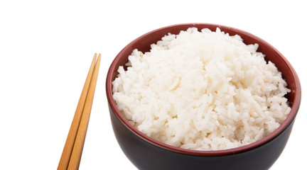 A bowl of rice and a pair of chopstick over white background