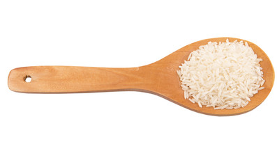 Raw and uncooked rice in wooden spoon over white background