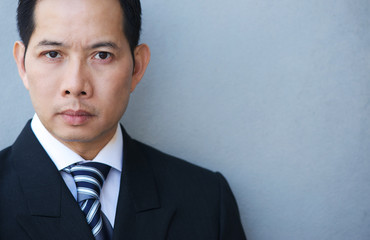 Smart businessman on gray background