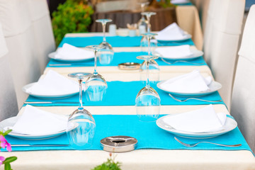 Beautiful tables with kitchenware in a summer cafe