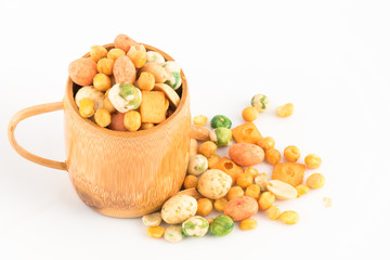 Nuts in bamboo cup on white background
