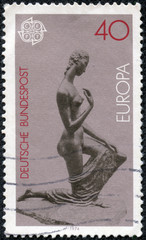 stamp printed in the Germany shows Kneeling Woman