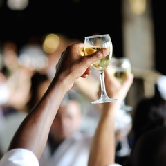 Men's hand holding wine glass