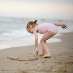 Little girl on a sand beach