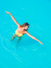 A girl is relaxing in a swimming pool