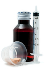 Bottle of medicine, pills and syringe isolated on white