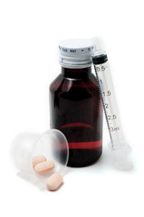 Bottle of medicine, pills and syringe isolated on white