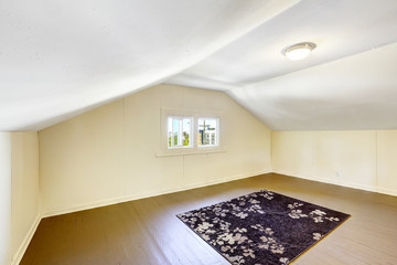 Empty room with vaulted ceiling.