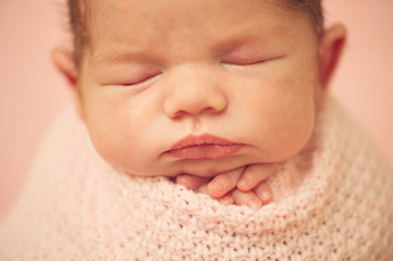 Newborn Baby in cocoon - close portrait of child
