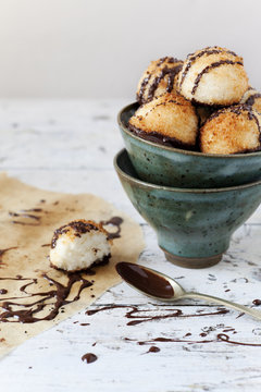 homemade coconut macaroons with dripped dark chocolate on bowl